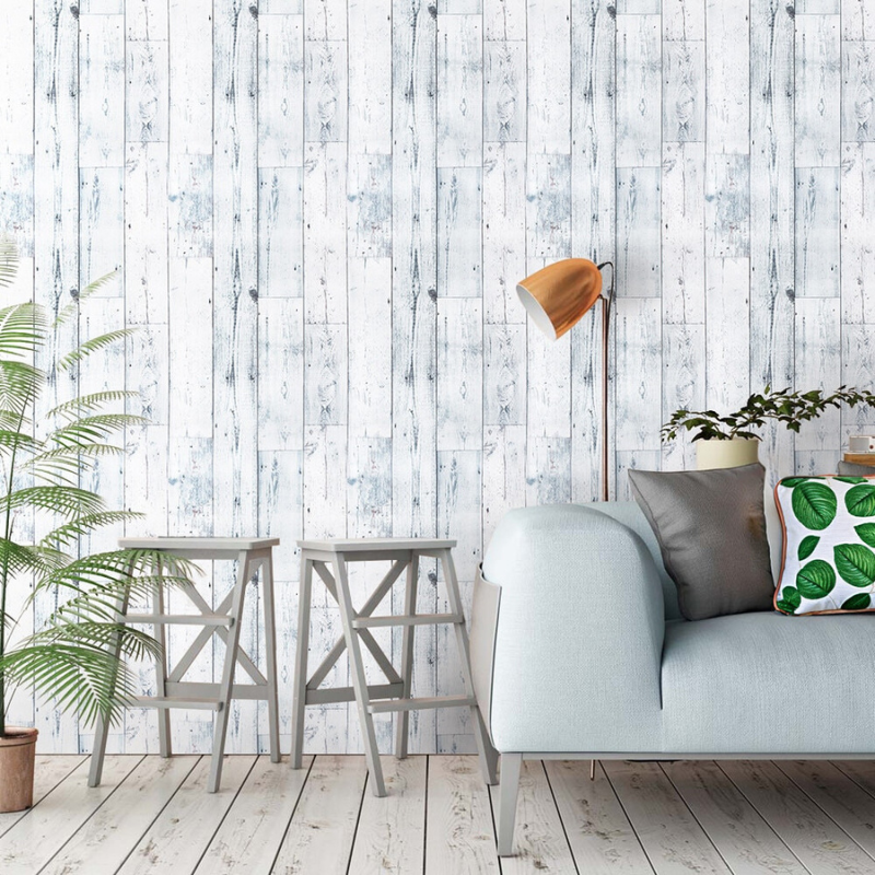 Faux Wood Wallpaper from Earth to Daisy with grey chairs and blue couch and a tall houseplant